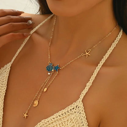 Elegant Gold Necklace with Blue Star and Shell