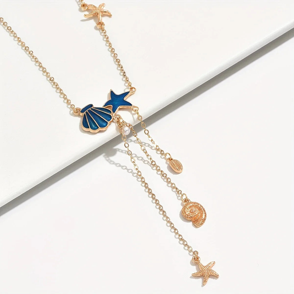 Elegant Gold Necklace with Blue Star and Shell